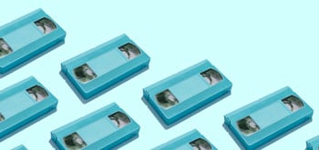 Multiple blue VHS tapes arranged diagonally on a light blue background[^i^].